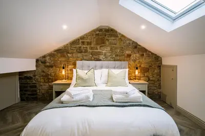 a bedroom with a large bed with two night stands at Sun Street Retreats in Lancaster