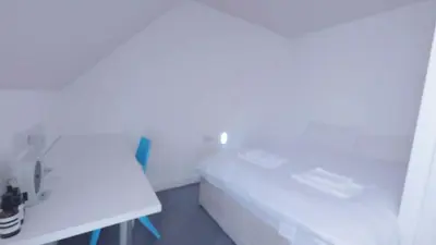 a small white room with a bed and a table at Stylish 3BDR New Build Home In Everton Park in Liverpool