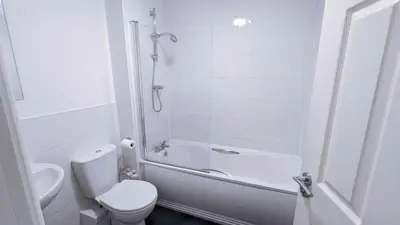 a white bathroom with a toilet and a shower at Stylish 3BDR New Build Home In Everton Park in Liverpool