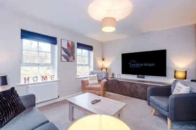 a living room with a couch and a tv at Spacious 3 bedroom home with garden in Heapey