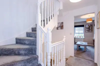 a staircase in a home with white railings at Spacious 3 bedroom home with garden in Heapey