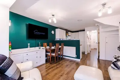 a kitchen and dining room with a table and chairs at Spacious 3 bedroom home with garden in Heapey