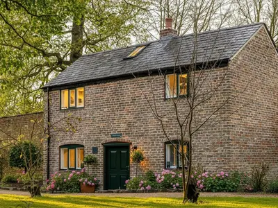 a brick house with a green door at The Gardeners Cottage at Lytham Hall in Lytham St Annes