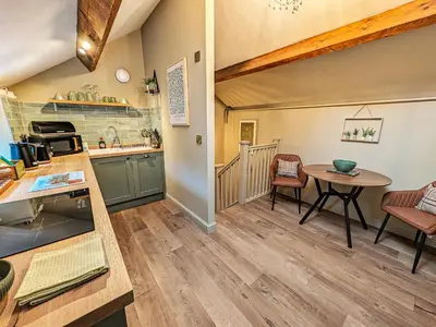 a kitchen and dining room with a table and chairs at The Gardeners Cottage at Lytham Hall in Lytham St Annes