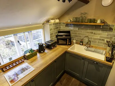 a kitchen with a sink and a counter at The Gardeners Cottage at Lytham Hall in Lytham St Annes