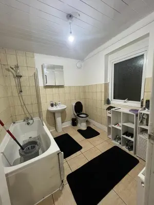 a bathroom with a tub and a toilet and a sink at Homey room in Liverpool