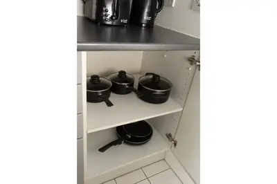 a shelf with pots and pans in a kitchen at Central Albert Dock 2Bed 2Bath in Liverpool