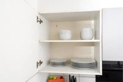 a kitchen cabinet with plates and bowls in it at Central Albert Dock 2Bed 2Bath in Liverpool
