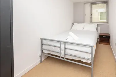 a bedroom with a bed with towels on it at Central Albert Dock 2Bed 2Bath in Liverpool
