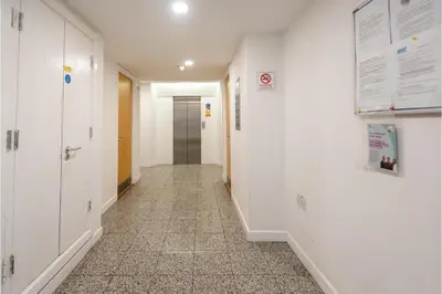 a hallway with white walls and a tile floor at Central Albert Dock 2Bed 2Bath in Liverpool