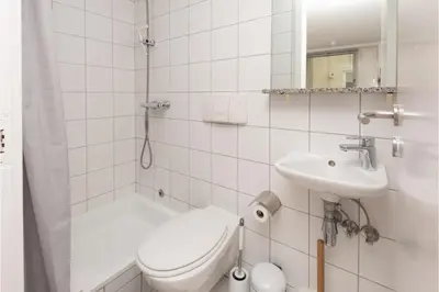 a white bathroom with a toilet and a sink at Central Albert Dock 2Bed 2Bath in Liverpool