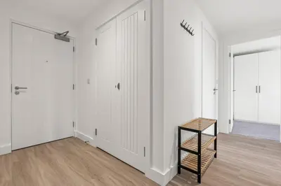 a room with white walls and a wooden floor at Business Stays, Modern Liverpool Flat, sleeps 4 in Liverpool