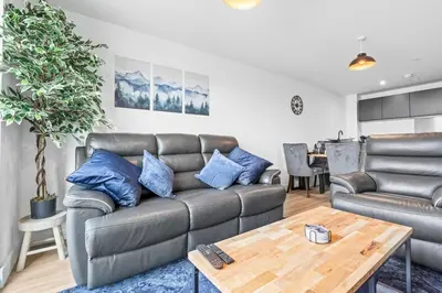 a living room with a couch and a table at Business Stays, Modern Liverpool Flat, sleeps 4 in Liverpool