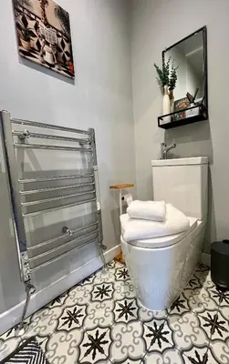 a bathroom with a toilet and a shower at Victoria suites in Southport