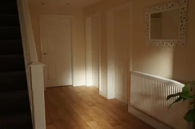 a hallway with a white door and a mirror at Forest View Holiday Park in Burscough