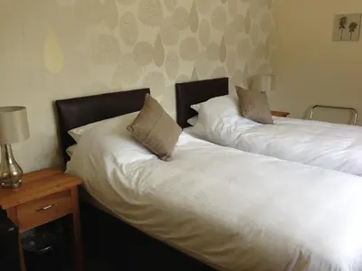 two beds sitting next to each other in a room at Forest View Holiday Park in Burscough