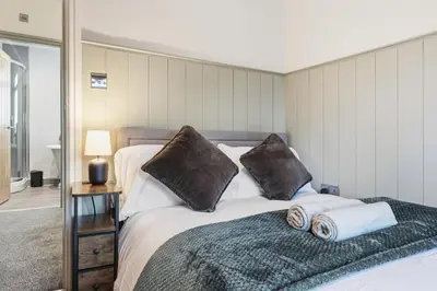a bedroom with a bed with two pillows on it at Spacious 4B home, great for contractors and families in Wigan