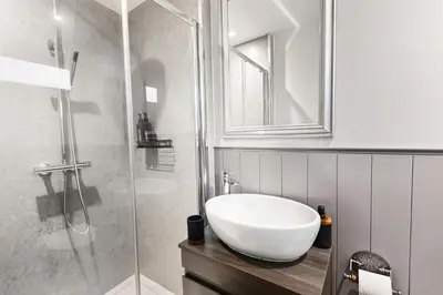 a bathroom with a sink and a shower at Spacious 4B home, great for contractors and families in Wigan