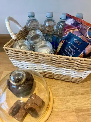 a basket of water bottles and a plate of food at Seaside Serenity in Lytham St Annes
