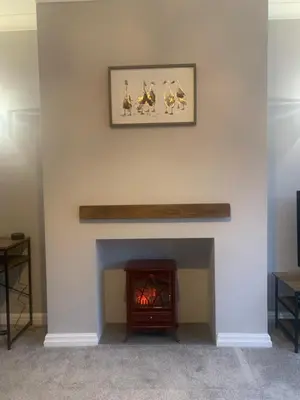 a living room with a fireplace with a picture on the wall at Seaside Serenity in Lytham St Annes
