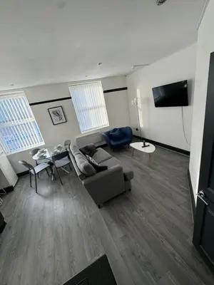 a living room with a couch and a table at The residency appartment's in Litherland