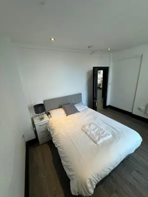 a bedroom with a large white bed in a room at The residency appartment's in Litherland