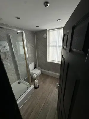 a bathroom with a shower and a toilet in it at The residency appartment's in Litherland