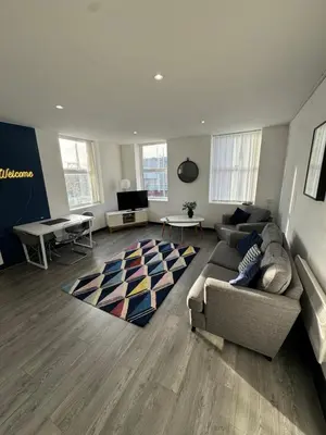 a living room with a couch and a table at The residency appartment's in Litherland
