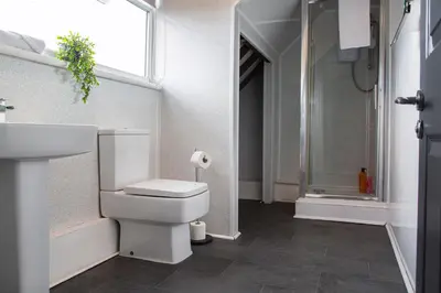 a bathroom with a toilet and a sink and a shower at The residency appartment's in Litherland