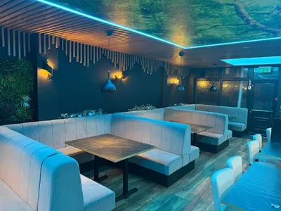 a restaurant with couches and a table and chairs at Woodhouse Hotel Blackpool Promenade in Blackpool
