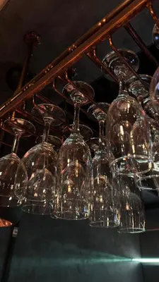 a bunch of wine glasses hanging from a rack at Woodhouse Hotel Blackpool Promenade in Blackpool