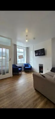 a living room with a couch and a fireplace at Cozy Stays Lancaster in Lancaster