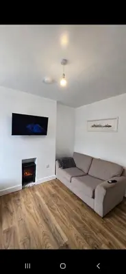 a living room with a couch and a fireplace at Cozy Stays Lancaster in Lancaster