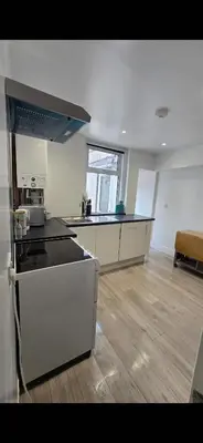 a kitchen with a stove top oven in a room at Cozy Stays Lancaster in Lancaster
