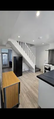 an empty kitchen with a staircase in a house at Cozy Stays Lancaster in Lancaster