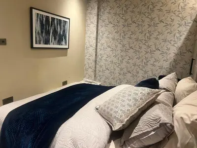 a bed with two pillows on it in a bedroom at 2 bedroom self catering detached outhouse with garden area in Preston
