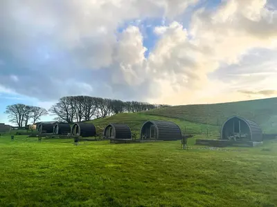 a group of domes in a field with a hill at Meadow - Uk48483 in Dalton in Furness