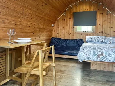 a room with a bed and a table and a table and chairs at Meadow - Uk48483 in Dalton in Furness