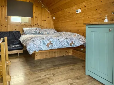 a bedroom with a bed in a wooden cabin at Meadow - Uk48483 in Dalton in Furness