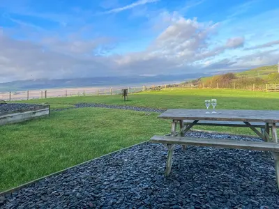 a picnic table with two wine glasses on it at Hardknot - Uk48484 in Dalton in Furness