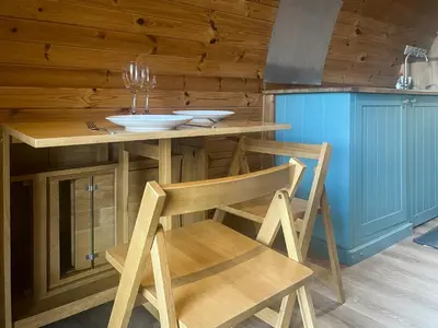 a wooden kitchen with a table and a chair at Hardknot - Uk48484 in Dalton in Furness