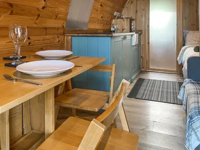 a kitchen with a wooden table with plates on it at Hardknot - Uk48484 in Dalton in Furness