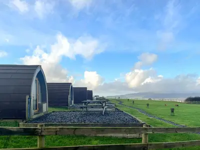 a picnic table in a field next to a building at Hardknot - Uk48484 in Dalton in Furness