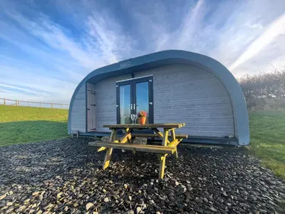 a small shed with a picnic table in front of it at Orchard - Uk48490 in Dalton in Furness