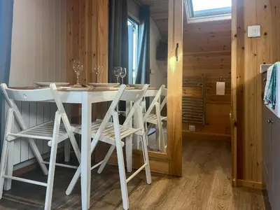 a dining room with a white table and chairs at Orchard - Uk48490 in Dalton in Furness