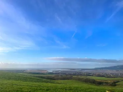 a green field with a blue sky in the background at Orchard - Uk48490 in Dalton in Furness