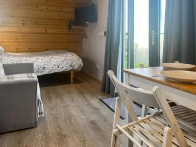 a room with a bed and a table and chairs at Orchard - Uk48490 in Dalton in Furness