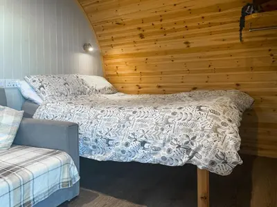 a bedroom with two beds and a wooden wall at Orchard - Uk48490 in Dalton in Furness