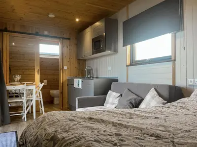 a bedroom with a bed and a kitchen with a table at Orchard - Uk48490 in Dalton in Furness