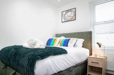 a bedroom with a large bed with a green blanket at Stylish Preston Home 3 Beds Sleeps 6 in Preston
